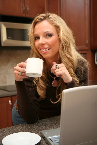 Kobieta pije kawę przy komputerze — Zdjęcie stockowe