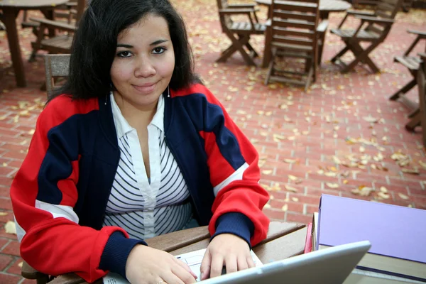 Teenager on computer outside — Stock Photo, Image
