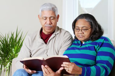 Senior Hipanic Couple Reading Bible clipart