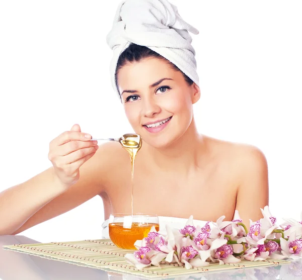 Beauty women eat honey — Stock Photo, Image