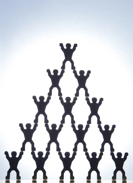 stock image Model Figures Forming Pyramid
