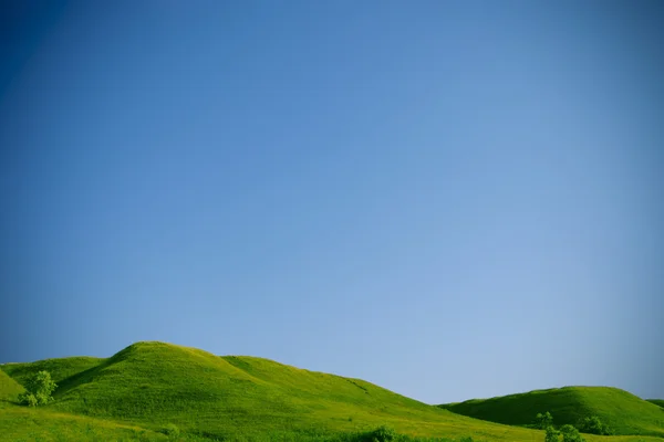 stock image Green hills and blue sky