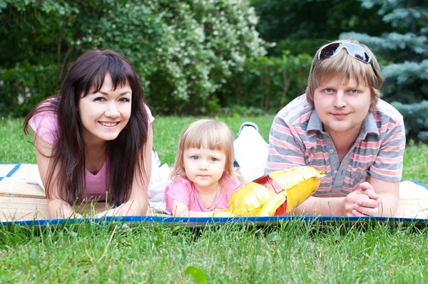 Young family lying — Stock Photo, Image
