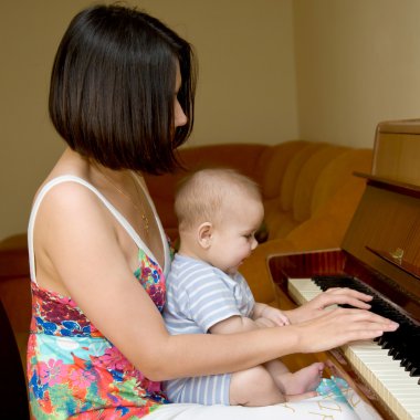 Baby play the piano clipart