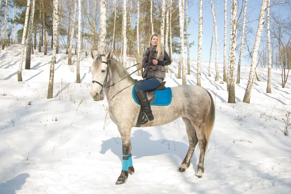 stock image Blonde girl sitting on pale horse