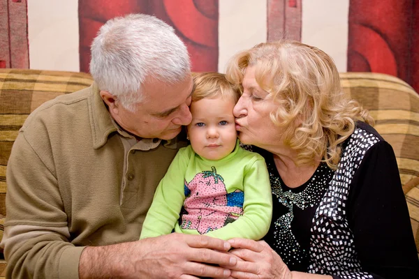 Avós beijando bebê — Fotografia de Stock