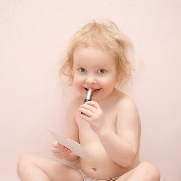 Baby girl with lipstick. — Stock Photo, Image