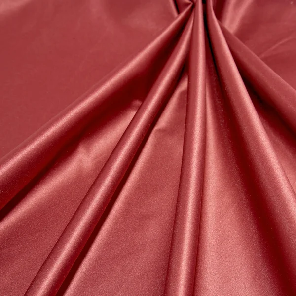 Folds of glossy smooth red satin fabric. — Stock Photo, Image