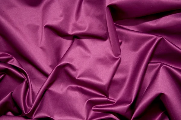 Pieghe di tessuto raso viola liscio lucido — Foto Stock
