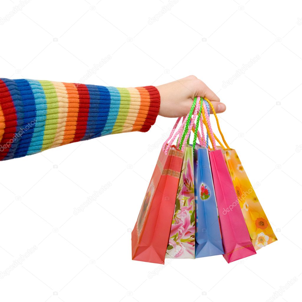 Women's hand in a rainbow colorful dress holding some shopping bags as logo. Isolated on white background with clipping path