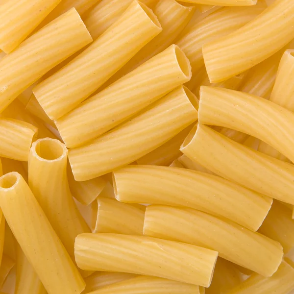 Nahaufnahme von ungekochter italienischer Pasta - Penne als Hintergrund — Stockfoto