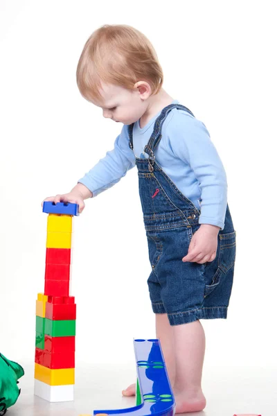 Small child building tower from cubes Royalty Free Stock Photos