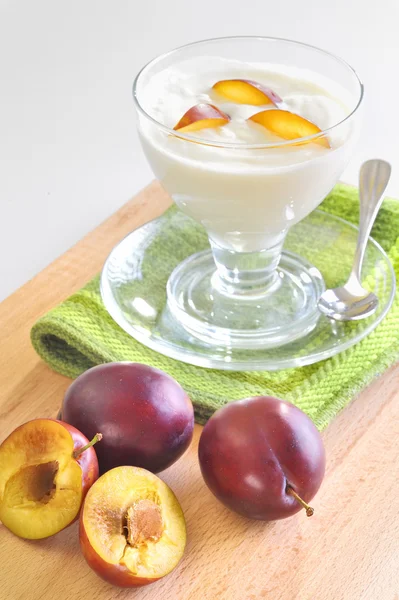 Yogurt and plums fruit — Stock Photo, Image