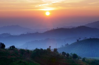 Landscape of sunrise over mountains in Kanchanaburi,Thailand clipart