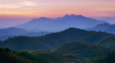 Landscape of sunrise over mountains in Kanchanaburi,Thailand clipart