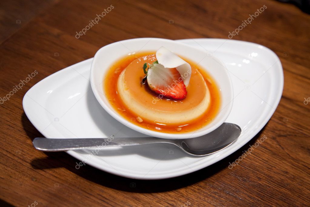 Custard cake with strawberry topping on wood table background
