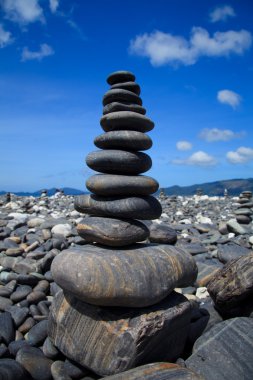 Stack of stones on the Hin nam beach, Lipe, Thailand clipart