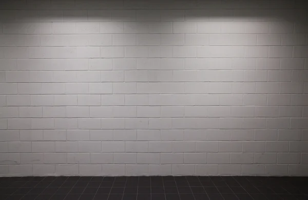 stock image White brick wall pavement with dim lighting