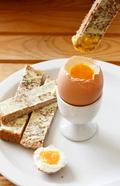 Boiled egg and buttered toast — Stock Photo, Image