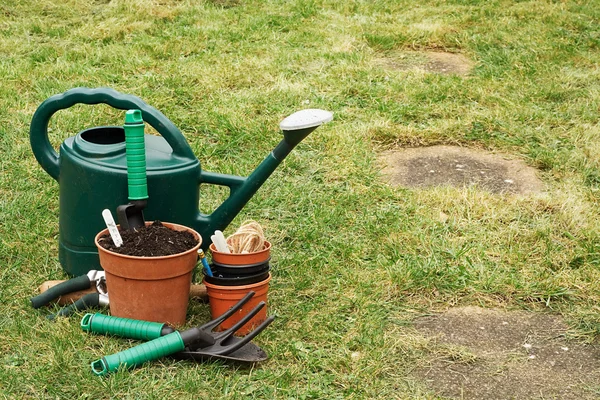 Gardening implements on the grass lawn — Stock Photo, Image
