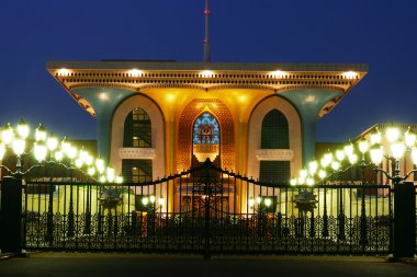 Oriental architecture, sultan's palace in Oman at night clipart