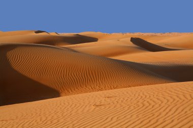 Sand dunes in a desert clipart