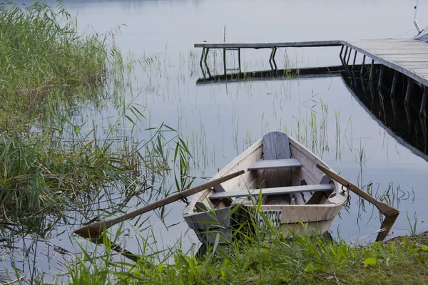 stock image Wooden boat on the lake shore