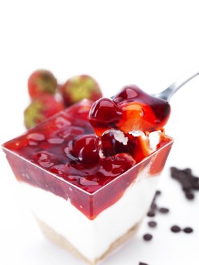 Cheese cake in a glass bowl with cherries and strawberries clipart