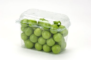 Green plums(greengages) in a plastic box clipart