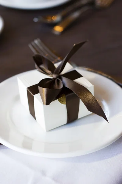 stock image Present little white box with brown bow