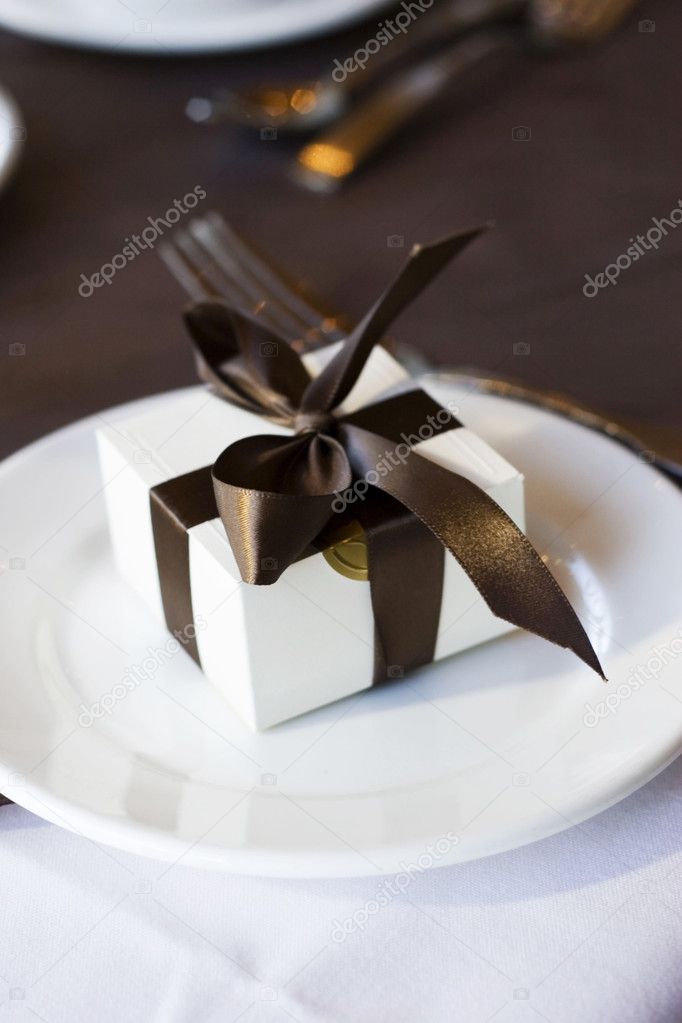 Present little white box with brown bow