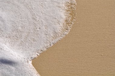 Beach Background with Sand and Foam from the Ocean Sea clipart