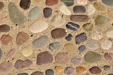 Colorful Stones in Sand Background clipart