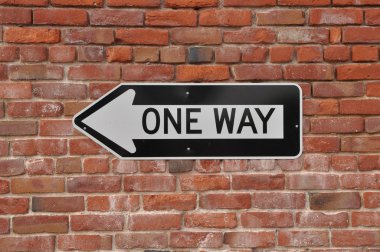 Brick Wall with One Way Sign clipart