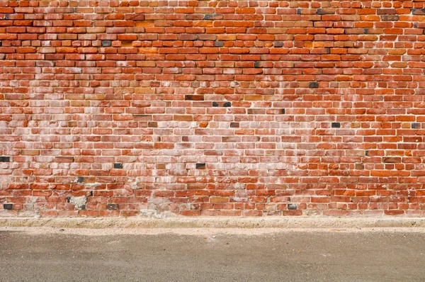 Oude bakstenen muur en weg straat — Stockfoto