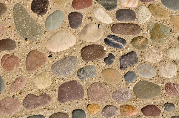 Kolorowe kamienie w tle piasek — Zdjęcie stockowe