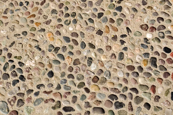Piedras coloridas en el fondo de arena — Foto de Stock