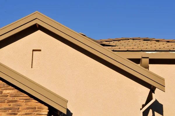 stock image New Stucco Home Under Construction with Blue Sky