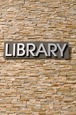 Library Sign on a stone wall clipart