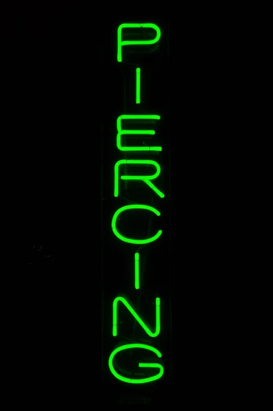 Green Piercing Neon Sign Light — Stock Photo, Image