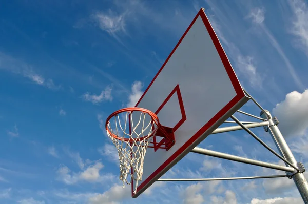 Koszykówka obręcz z chmury i błękitne niebo — Zdjęcie stockowe