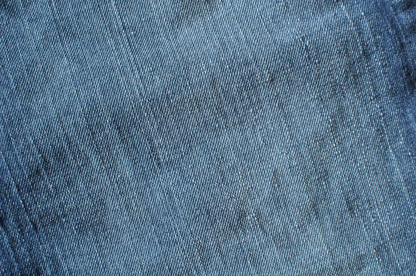 Calça jeans azul desgastada feita de tecido de ganga — Fotografia de Stock