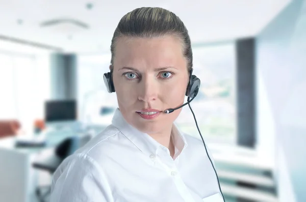 Blondy beautiful girl speaking over the headset — Stock Photo, Image