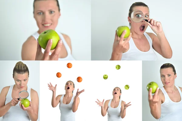 Healthy blondy happy woman plays and looks apples oranges — Stock Photo, Image