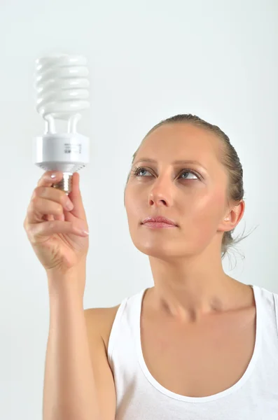 stock image Beautiful young woman having an idea with holding an bulb