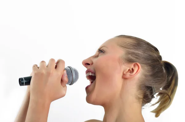 Sexy schöne junge Frau singt mit einem Mikrofon — Stockfoto