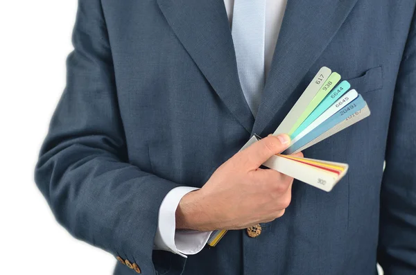 Бізнесмен тримає кольорову путівник книгу ізольовано на білому — стокове фото