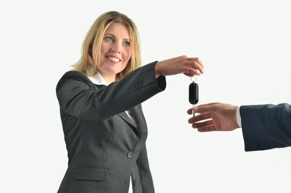 Businesswoman giving keys to businessman — Stock Photo, Image