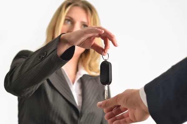 Geschäftsfrau übergibt Schlüssel an Geschäftsmann — Stockfoto