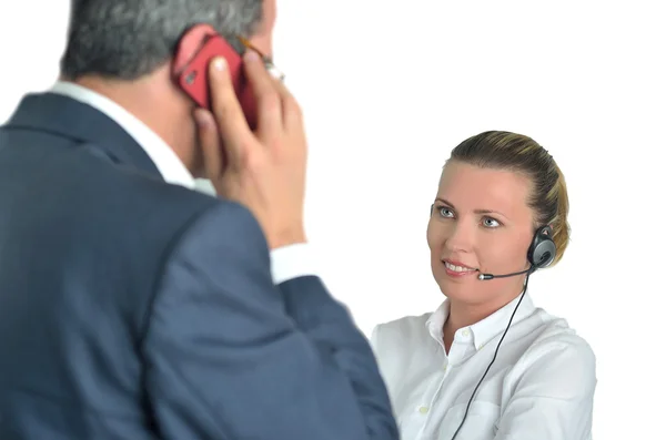 Beautiful business woman with headset and talking to a businessm — Stock Photo, Image